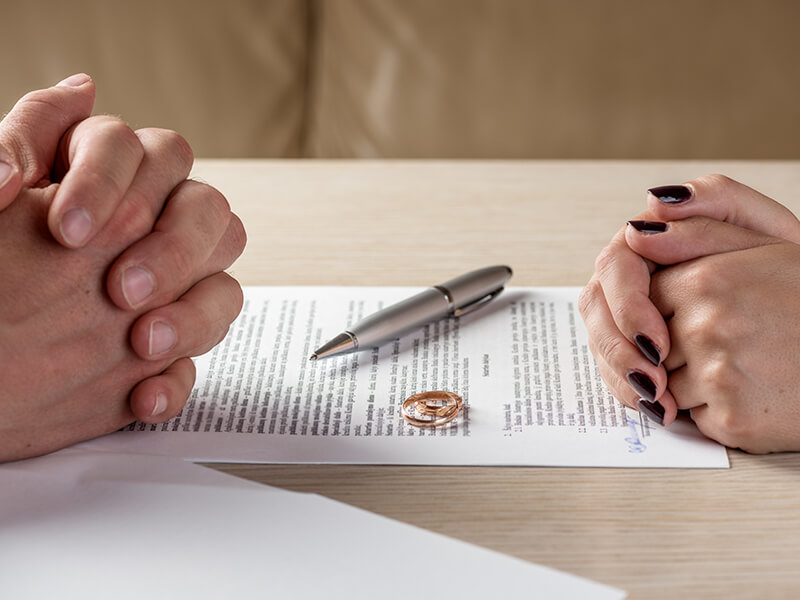 Wife and husband signing divorce documents